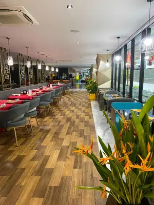a restaurant with tables and chairs and plants at Private apartments near Kata beach in Kata Beach
