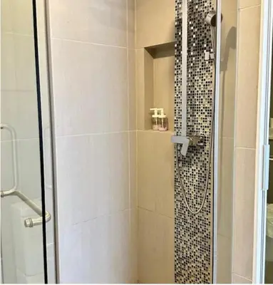 a bathroom with a shower with a glass door at Oceanstone condo Bangtao Beach in Bang Tao Beach