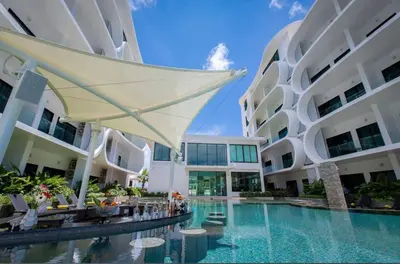 a swimming pool in the middle of a building at Modern apartment on Naiharn Beach B404 in Rawai Beach