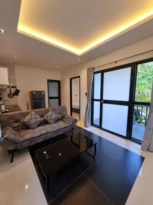 a living room with a couch and a table at Nua tone riverside resort in Ban Thalat Choeng Thale
