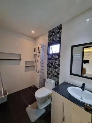 a bathroom with a toilet and a sink at Nua tone riverside resort in Ban Thalat Choeng Thale