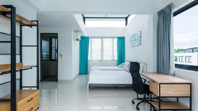 a bedroom with a bed and a desk and a desk chair at Laguna Park 2 Family Pool Villa near Bang Tao Beach in Bang Tao Beach