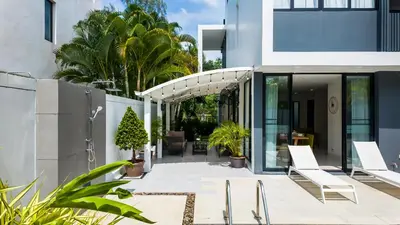 an outdoor patio with chairs and plants in a building at Laguna Park 2 Family Pool Villa near Bang Tao Beach in Bang Tao Beach