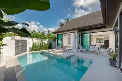 a swimming pool in a backyard with a house at Villa Plunge Modern 2-Bedroom with Private Pool in Rawai Beach