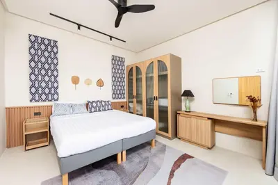 a bedroom with a bed and a desk at Villa Plunge Modern 2-Bedroom with Private Pool in Rawai Beach