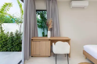 a bedroom with a desk and a white chair at Villa Plunge Modern 2-Bedroom with Private Pool in Rawai Beach