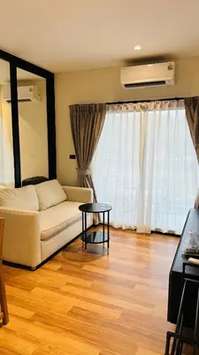 a living room with a couch and a table at The Title Halo 1 Naiyang beach in Nai Yang Beach