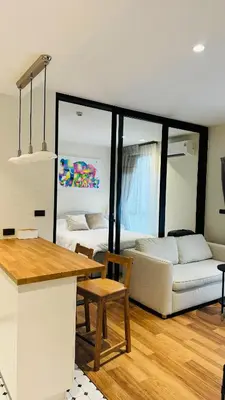 a kitchen and living room with a couch and a table at The Title Halo 1 Naiyang beach in Nai Yang Beach