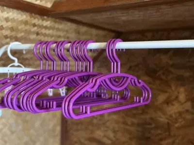 a purple hose is hanging on a rack at Bangtao Wooden house resort and cafe in Ban Thalat Choeng Thale