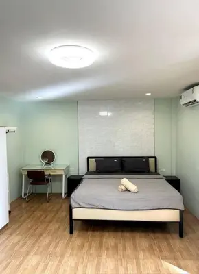 a bed in a room with a desk and a bed sidx sidx sidx at Villa Patong Beach in Patong Beach