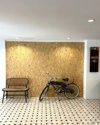 a bike parked against a wall next to a chair at Villa Patong Beach in Patong Beach