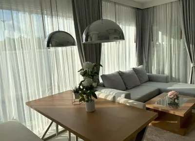 a living room with a couch and a table at Luxury villa Kamala Garden View by Lofty in Kamala Beach