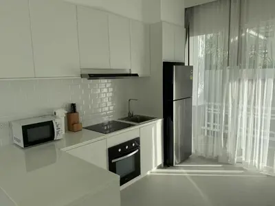 a white kitchen with a sink and a refrigerator at Luxury villa Kamala Garden View by Lofty in Kamala Beach