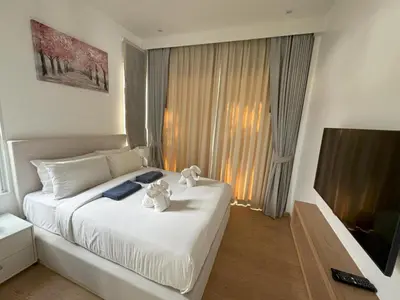 a bedroom with a bed with two stuffed animals on it at Luxury villa Kamala Garden View by Lofty in Kamala Beach