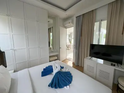 a bedroom with a bed with blue towels on it at Luxury villa Kamala Garden View by Lofty in Kamala Beach