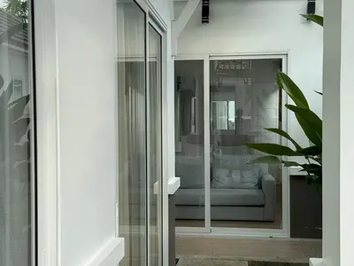 a glass storefront with a couch in a window at Luxury villa Kamala Garden View by Lofty in Kamala Beach