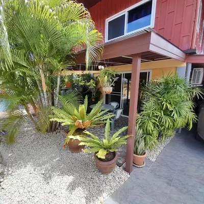 a house with a bunch of plants in front of it at 2,5 Zimmerwohnung mit Pool und Pavillon in Rawai Beach