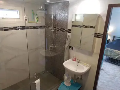a bathroom with a shower and a sink at 2,5 Zimmerwohnung mit Pool und Pavillon in Rawai Beach