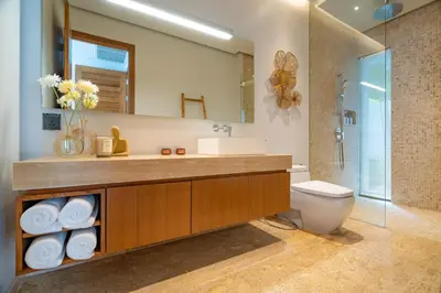 a bathroom with a sink and a toilet and a mirror at Modern 3BR Pool Villa at Anchan Flora in Bangtao in Bang Tao Beach
