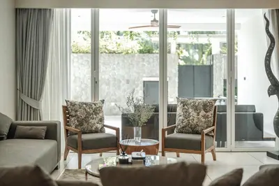 a living room with a couch and chairs and a table at Private Pool Residence at Surin Beach in Surin Beach