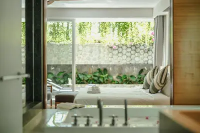 a bedroom with a bed and a large window at Private Pool Residence at Surin Beach in Surin Beach