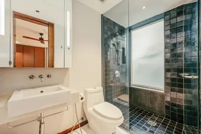 a bathroom with a toilet and a sink and a shower at Private Pool Residence at Surin Beach in Surin Beach