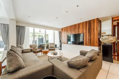 a living room with a couch and a tv at Private Pool Residence at Surin Beach in Surin Beach