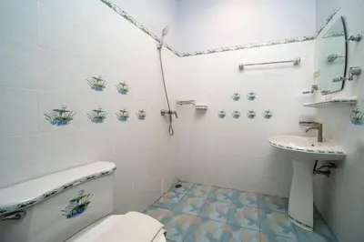 a bathroom with a toilet and a sink at Coast Charm 6BR House Karon in Karon Beach