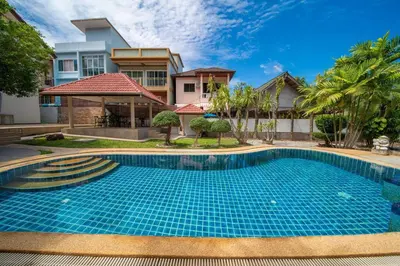 a swimming pool in front of a house at Coast Charm 6BR House Karon in Karon Beach