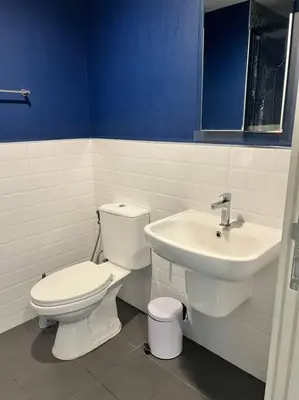 a bathroom with a toilet and a sink at The Base Central Phuket in Phuket Town