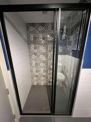 a shower with a glass door in a bathroom at The Base Central Phuket in Phuket Town