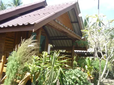 a wooden house with a metal roof at Pasai Beach Lodge in Ko Yao Noi