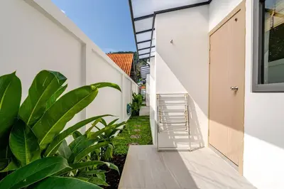 a staircase leading up to a house with plants at Oasis by the Sea M1- House with Pool and Amenities in Phuket Town