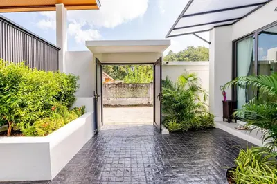 an open door to a house with plants at Oasis by the Sea M1- House with Pool and Amenities in Phuket Town