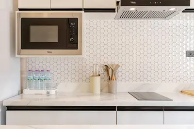 a kitchen with a white counter top with a microwave at Oasis by the Sea M1- House with Pool and Amenities in Phuket Town