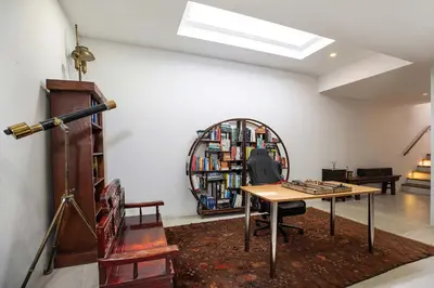 a room with a table and a book shelf with books at Ultra-Modern Tropical Pool Villa in Phuket