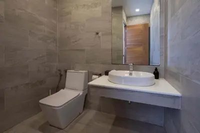 a bathroom with a sink and a toilet and a mirror at Ultra-Modern Tropical Pool Villa in Phuket