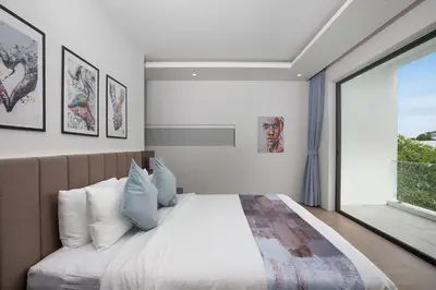 a bedroom with a large bed and a large window at Ultra-Modern Tropical Pool Villa in Phuket