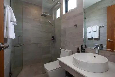a bathroom with a toilet and a sink and a shower at Ultra-Modern Tropical Pool Villa in Phuket