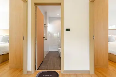 a room with a door leading to a bedroom at Oasis by the Sea M2- House with Pool and Amenities in Phuket Town