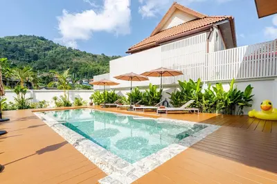 a swimming pool in the middle of a house at Oasis by the Sea M3- House with Pool and Amenities in Phuket Town