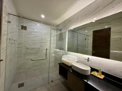a bathroom with a shower and a sink and a mirror at Deluxe Twin Bed Apartment by Renttini in Kamala Beach
