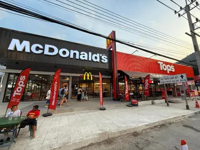 a mcdonalds store with people sitting in front of it at Deluxe Twin Bed Apartment by Renttini in Kamala Beach