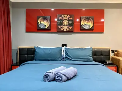 a bed with two rolled towels on top of it at Patong - Studio Condo - Absolute Bangla Unit in Patong Beach