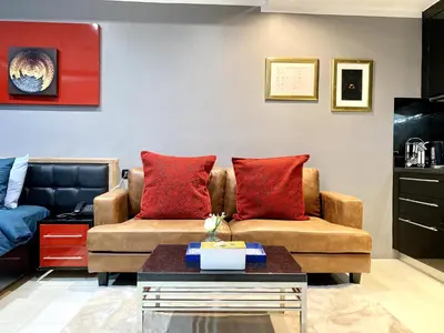 a living room with two couches and a coffee table at Patong - Studio Condo - Absolute Bangla Unit in Patong Beach