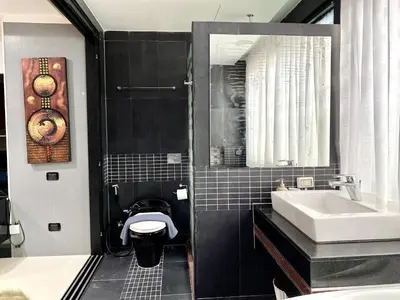 a bathroom with a sink and a toilet and a mirror at Patong - Studio Condo - Absolute Bangla Unit in Patong Beach