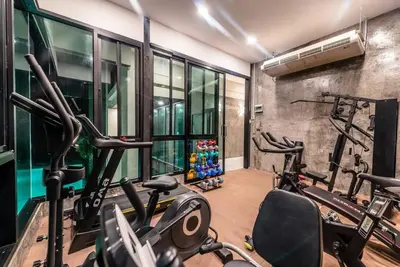 a gym with several cardio machines in a room at Sunset Mountain View 2bedroom Patong in Patong Beach