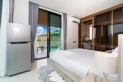 a bedroom with a white bed and a large window at Sunset Mountain View 2bedroom Patong in Patong Beach