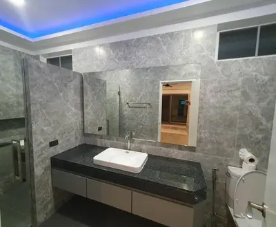 a bathroom with a sink and a mirror and a toilet at Modern pool villa 3 bedrooms in Rawai Beach