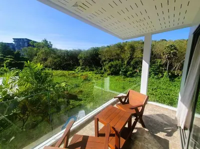 a balcony with two chairs and a table and a window at Modern pool villa 3 bedrooms in Rawai Beach